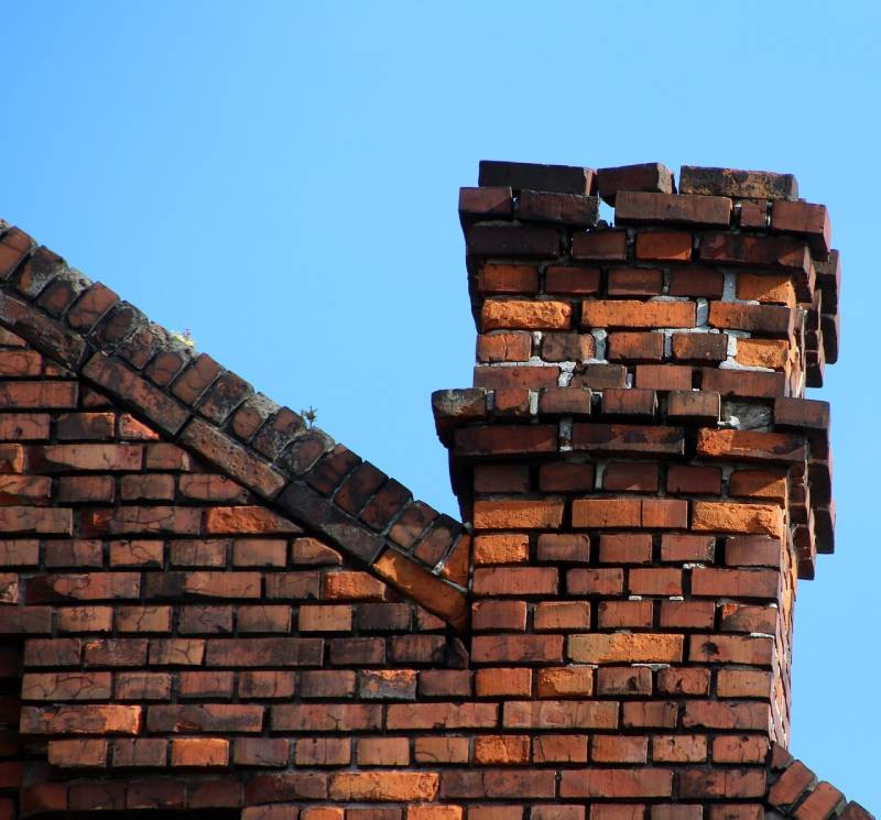 Damaged chimney on an El Toro home showing cracks and missing mortar
